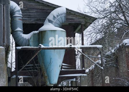 Abandoned Industrial Cyclone Collector in Snowy Estonian Winter Stock Photo