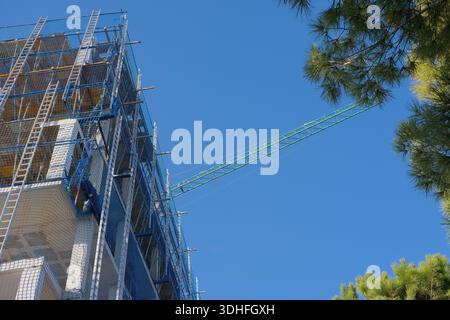 Construction crew working on housing development site with blurred background and clear skies Stock Photo