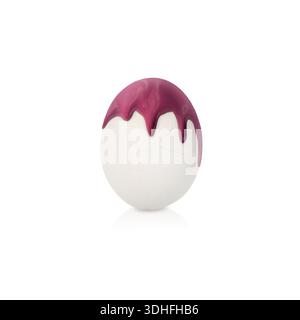 Paint dripping down egg on white background. Easter celebration Stock Photo