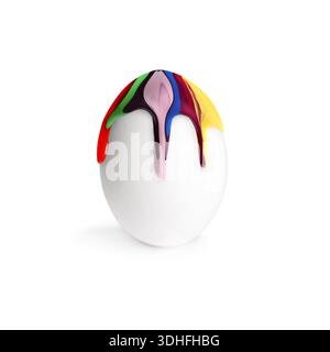 Colorful paint dripping down egg on white background. Easter celebration Stock Photo