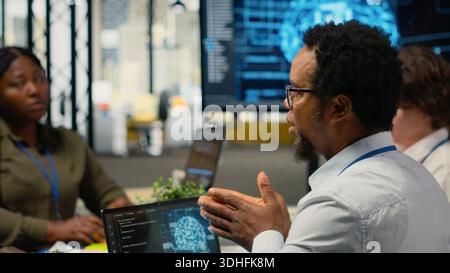 System administrators working in AI startup training predictive models for language processing tasks. Machine learning tech experts use technical expertise for complex IT requirements, camera B Stock Photo