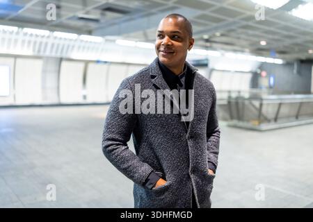 Confident young businessman commuting in a modern subway station Stock Photo