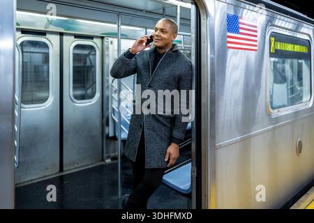 Businessman commuting on subway making a phone call in new york Stock Photo