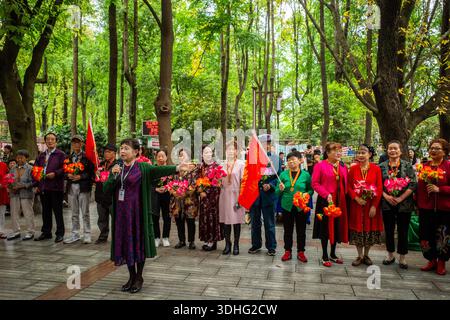 A group of elderly people participating in a colorful musical event at the People's Park in Chengdu, China. Stock Photo