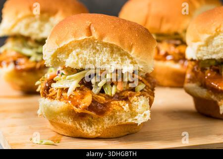 Savory Homemade Pulled Chicken Sliders with Sauce and Coleslaw Stock Photo