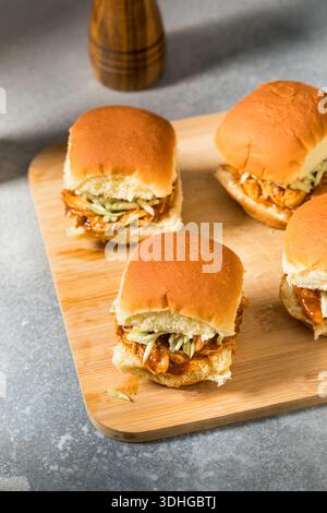 Savory Homemade Pulled Chicken Sliders with Sauce and Coleslaw Stock Photo