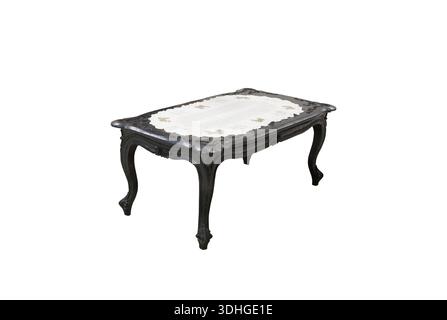 A classic wooden table decorated with carvings with a white tablecloth on top Stock Photo