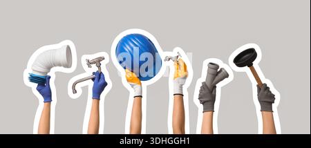 Hands with hardhat and plumber's tools on grey background Stock Photo