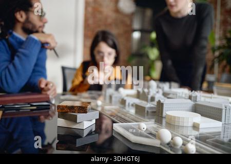 Multiethnic Young Adults Collaborating on Urban Architectural Model Project Stock Photo