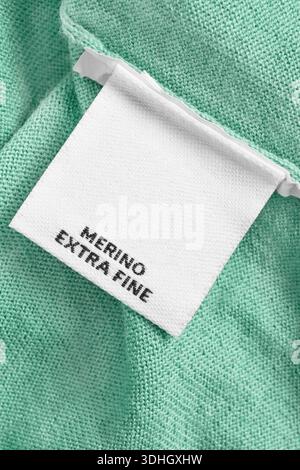 Clothes label text Merino Extra Fine on mint color wool background Stock Photo