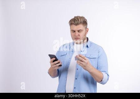 Man using smartphone and smiling in a studio Stock Photo