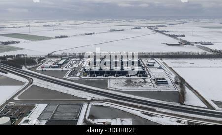 Aerial view of a stark, snow-covered landscape where a modern datacenter stands out against the icy fields, Datacenter Middenmeer, North Holland, Neth Stock Photo