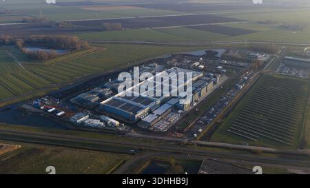 Aerial view of the sprawling Google Data Center, a fortress of technology amidst a landscape of agricultural fields, Winschoten, Groningen, Netherland Stock Photo