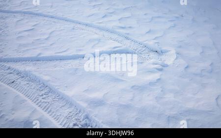 Snow surface texture with intersecting tire tracks and soft winter relief Stock Photo