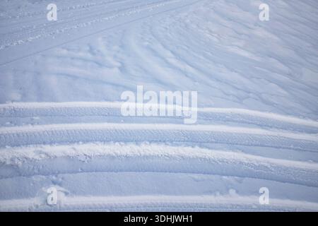 Snow surface texture with intersecting tire tracks and soft winter relief Stock Photo
