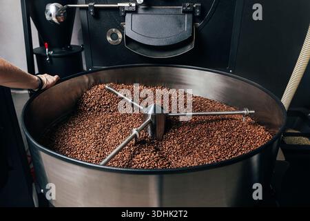 Industrial coffee roasting machine with cooling drum full of fresh beans Stock Photo