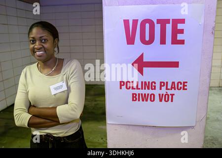 Miami Beach Florida,Election Day,Black African Africans woman female women,vote polling place sign multiple language languages English Creole, Stock Photo