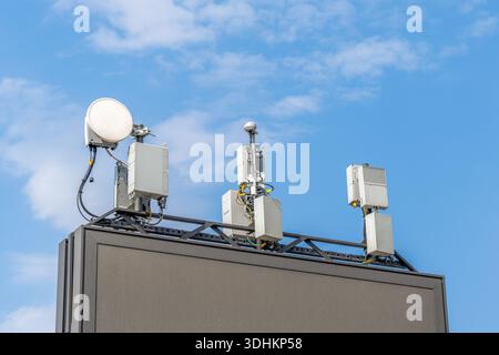 A mobile base station installed on an advertising billboard. Cell phone Stock Photo