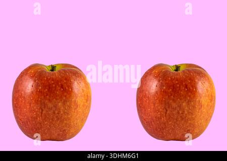 two apples on a pink background Stock Photo