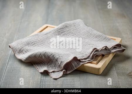wooden cutting board and linen napkin on rustic table background Stock Photo