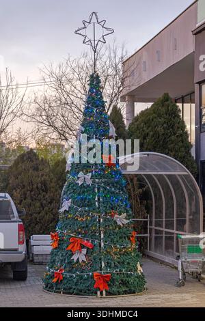 Large Christmas Tree in Front of Shopping Mall Winter Festive Decoration Stock Photo