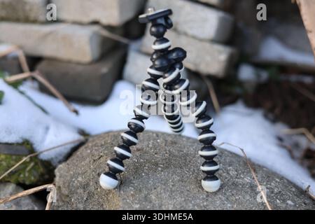 A mini flexible bendy camera tripod, photographers or filmmakers equipment Stock Photo