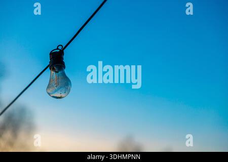 Frozen lightbulb with icicle and snow Stock Photo