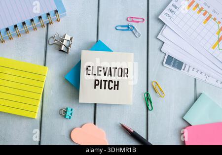 elevator pitch text message on white paper and office supplies, pen, paper note, on white desk Stock Photo
