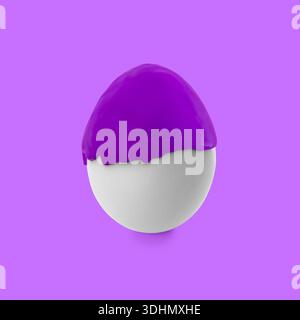 Paint dripping down egg on violet background. Easter celebration Stock Photo