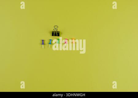 Colorful push pins on yellow-green surface highlight organization, planning, and visual contrast in office or educational settings. Stock Photo