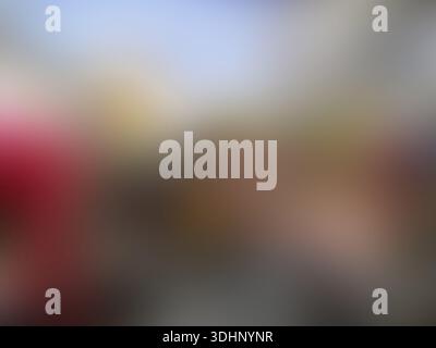 Softly blurred abstract background featuring a palette of blue, yellow, red, and grey, creating a smooth and dreamy bokeh effect for creative designs. Stock Photo