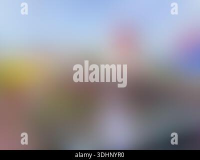 Softly blurred abstract background featuring a palette of blue, yellow, red, and grey, creating a smooth and dreamy bokeh effect for creative designs. Stock Photo