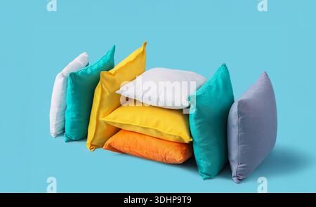Different colorful pillows on blue background Stock Photo