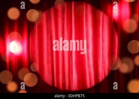 Shining spotlight on red curtain Stock Photo