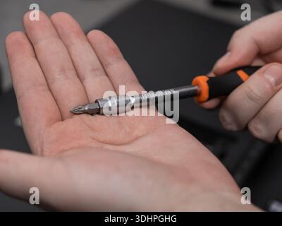 Close-up of a versatile multi-bit screwdriver, featuring an ergonomic handle and interchangeable tip, emphasizing precision and efficiency for profess Stock Photo