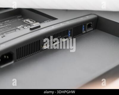 Close-up of a modern computer monitor's back panel, showing power, HDMI, USB, and LAN ports essential for versatile digital, business, and multimedia Stock Photo