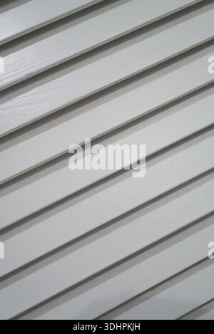 Diagonal white wooden slats creating a textured background with subtle shadows Stock Photo