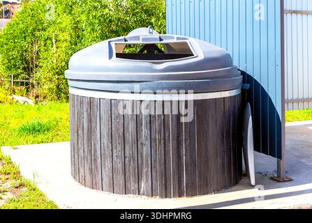 Big round garbage container for household waste at the city in summer Stock Photo