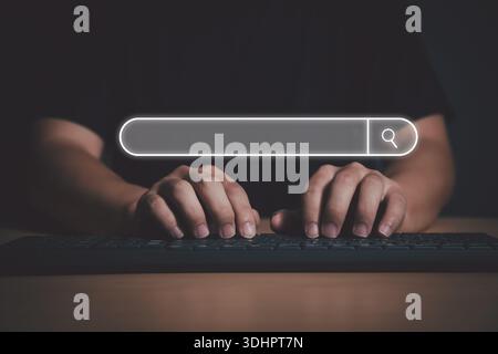 Man's hands are using a computer keyboard to Searching for information via big data search engine. Data Search Technology Search Engine Optimization. Stock Photo