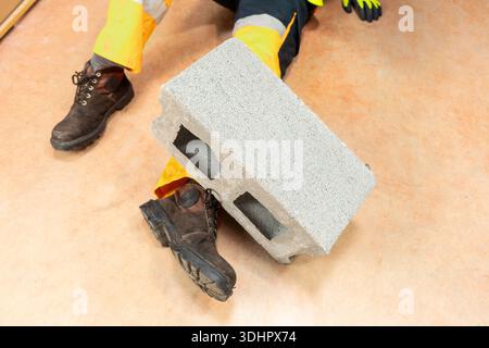 Male body lying on the floor after a work accident. Stock Photo