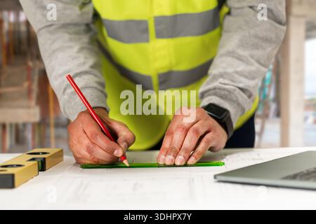 Engineering hands, drawing and blueprint planning at construction site, warehouse and outdoor development. Architecture contractor, project manager or Stock Photo