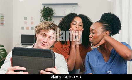 Trio Of Young Friends Collaborating In A Modern Startup Office With Tablet Stock Photo