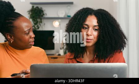 Diverse Startup Team Collaborating On Laptop In Modern Office Setting Stock Photo