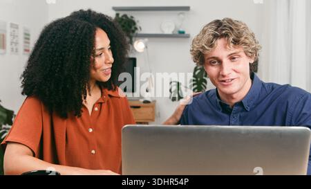 Young Team Collaborating On Laptop At Home Office For Startup Project And Friendship Stock Photo