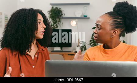 Diverse Team Members Discussing Startup Ideas In Modern Office With Laptop Stock Photo