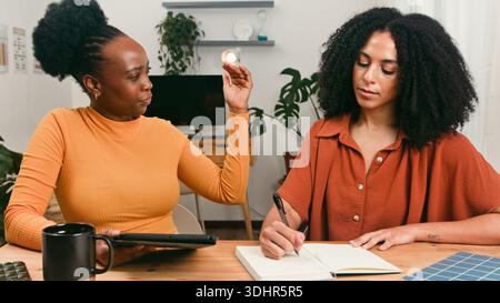 Diverse Startup Team Collaborates At Table During Creative Brainstorm Session In Bright Office Stock Photo