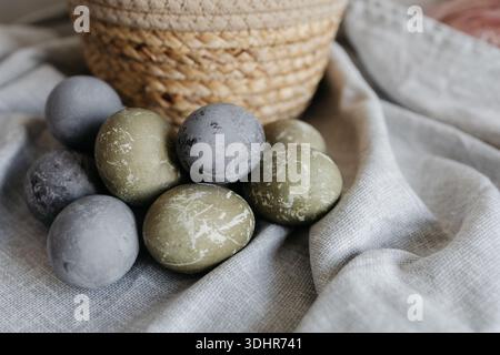 Easter holiday. Painted olive-colored eggs on a linen tablecloth. Easter decoration. Stock Photo