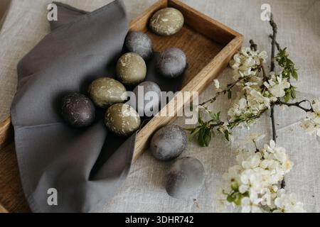 Easter holiday. Painted olive-colored eggs on a linen tablecloth. Easter decoration. Stock Photo