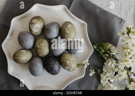 Easter holiday. Painted olive-colored eggs on a linen tablecloth. Easter decoration. Stock Photo