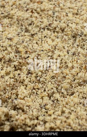 Detailed texture background of ground walnut kernels. Stock Photo